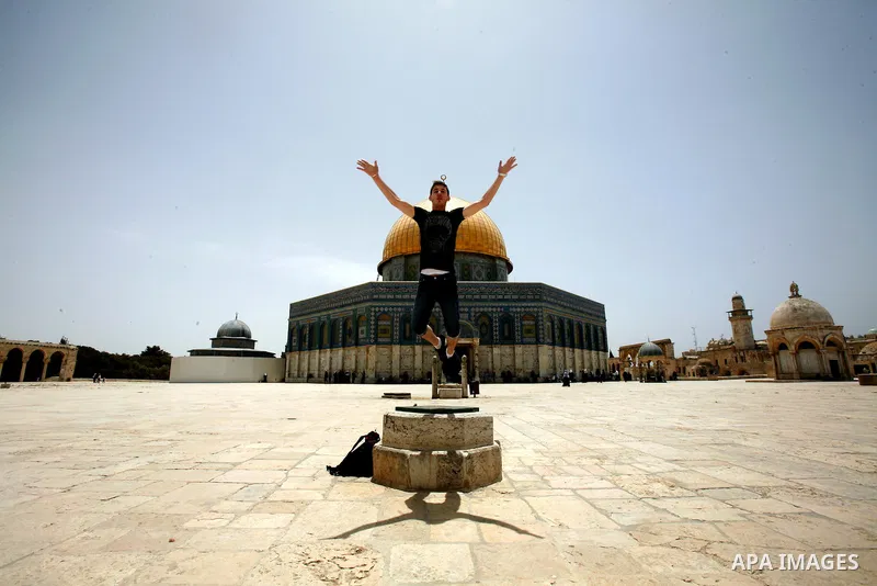 A Palestinian youth plays in front of the Dome of Rock inside the Al-Aqsa Mosque compound, Islam's third holiest site, in Jerusalem's Old City on May. 23, 2012. Photo by Mahfouz Abu Turk