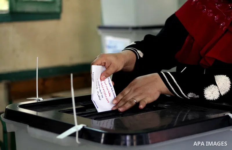 An Egyptian voter casts her ballots at one of the polling stations, on the first day of the presidential elections in Cairo, Egypt, 23 May 2012. Egyptian voters, on 23 May, queued at polling stations for the first Presid...