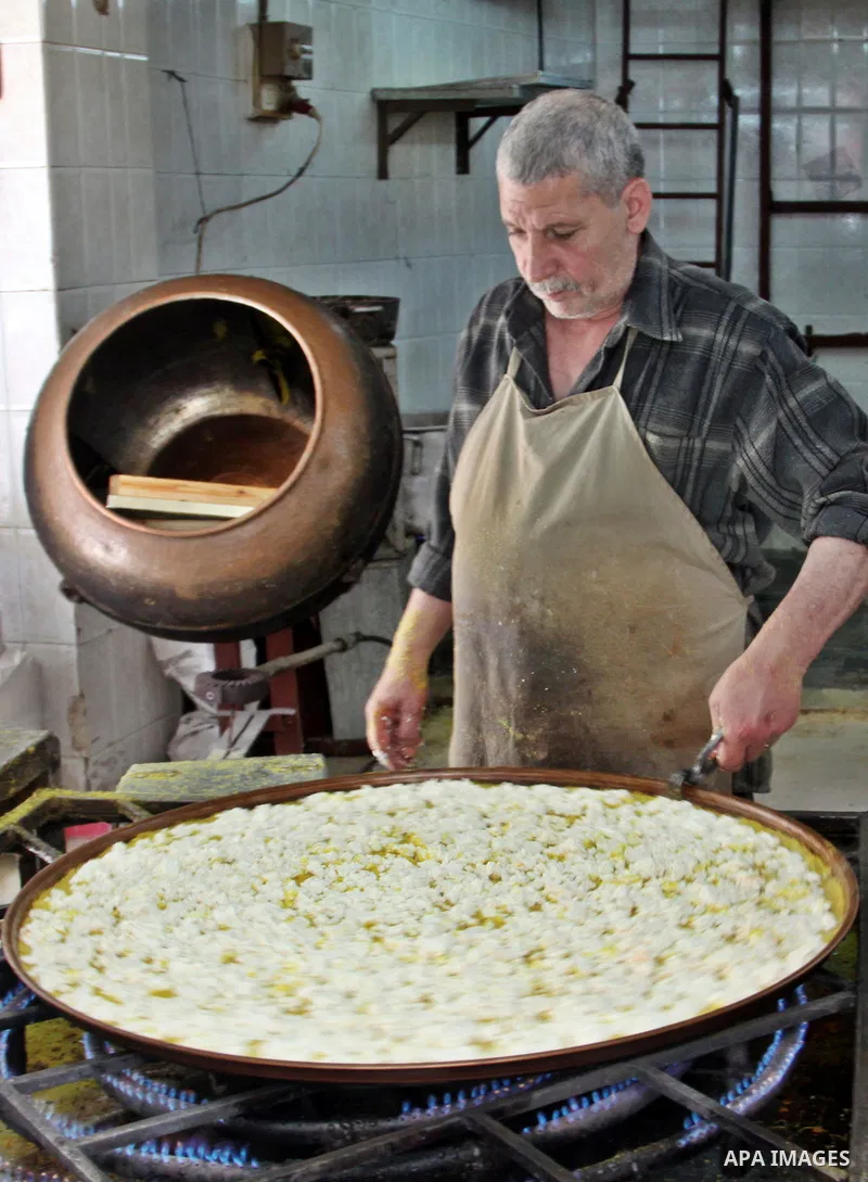 Palestinian baker prepares Nabulsi Kunafa, a traditional and favorite local sweet, in the West Bank, city of nablus on May 24, 2012. Photo by Nedal Eshtayah .