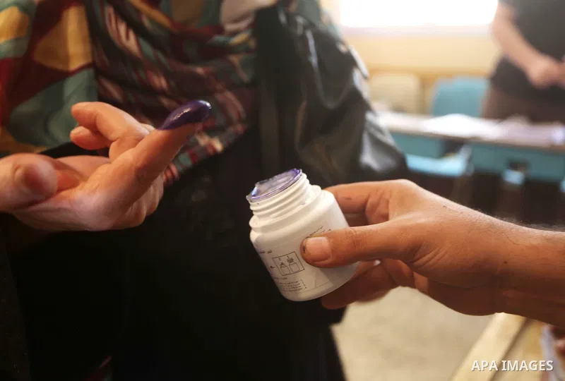 Egyptian woman dips her finger on the ink to cast her ballot during the first round of Egypt's presidential elections, at a polling station in Cairo, Egypt, 24 May 2012. for the first Presidential election since the oust...
