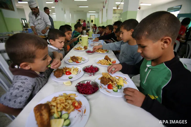 Palestinian orphan children eat lunch at the Hebron's orphan house, in the West Bank city of Hebron 24 May 2012. Hebron's orphan house contain about 100 orphan children from ages 6 to 18 years old, and oversees some of o...