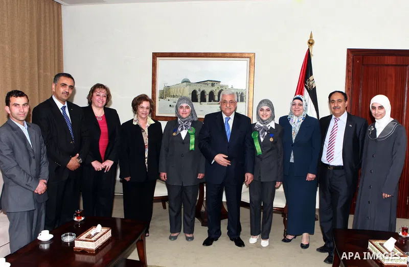 Palestinian President Mahmoud Abbas (Abu Mazen) meets with the two students, participat in contest International Science and Technology in ther West Bank city of Ramallah on May 24, 2012. Photo by Thaer Ganaim