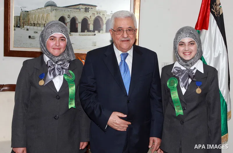 Palestinian President Mahmoud Abbas (Abu Mazen) meets with the two students, participat in contest International Science and Technology in ther West Bank city of Ramallah on May 24, 2012. Photo by Thaer Ganaim