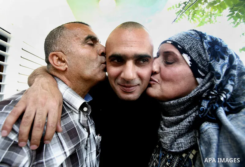 A Palestinian freed prisoner, Emad EL-Abasi, is welcomed by his relatives in the east Jerusalem neighborhood of Silwan on May 24, 2012. after he was released from an Israeli jails. Photo by Mahfouz Abu Turk