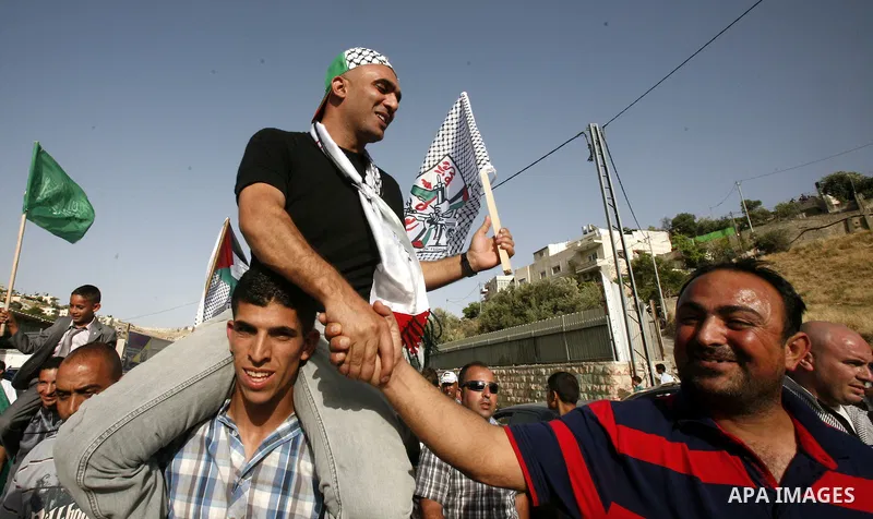 A Palestinian freed prisoner, Emad EL-Abasi, is welcomed by his relatives in the east Jerusalem neighborhood of Silwan on May 24, 2012. after he was released from an Israeli jails. Photo by Mahfouz Abu Turk
