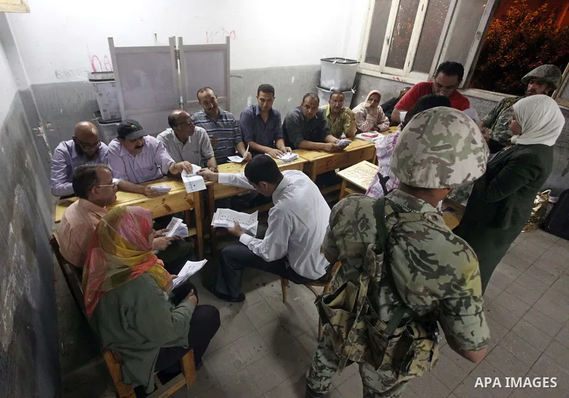 Egyptian election officials count ballots of the first round of Egypt's presidential elections, in a polling station in Cairo, Egypt, at the end of the election's second day on 24 May 2012. Polling stations closed at 9 p...