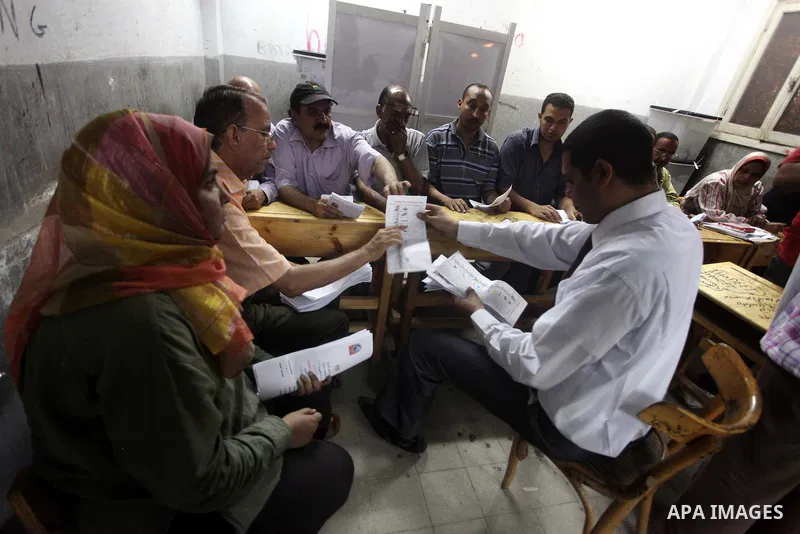Egyptian election officials count ballots of the first round of Egypt's presidential elections, in a polling station in Cairo, Egypt, at the end of the election's second day on 24 May 2012. Polling stations closed at 9 p...
