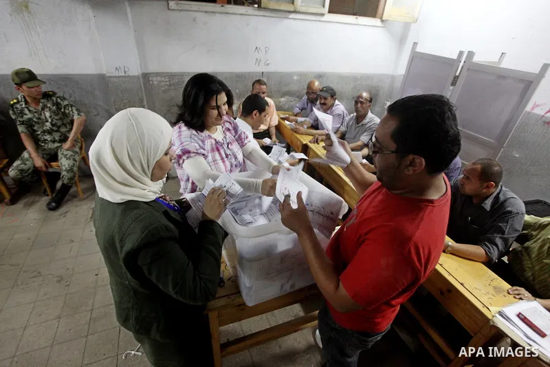 Egyptian election officials count ballots of the first round of Egypt's presidential elections, in a polling station in Cairo, Egypt, at the end of the election's second day on 24 May 2012. Polling stations closed at 9 p...