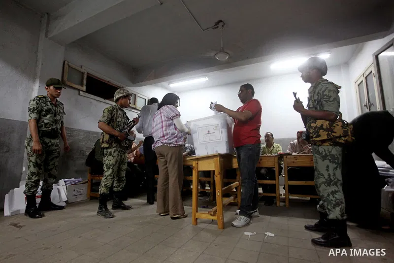 Egyptian election officials count ballots of the first round of Egypt's presidential elections, in a polling station in Cairo, Egypt, at the end of the election's second day on 24 May 2012. Polling stations closed at 9 p...
