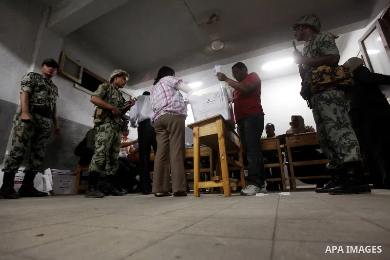 Egyptian election officials count ballots of the first round of Egypt's presidential elections, in a polling station in Cairo, Egypt, at the end of the election's second day on 24 May 2012. Polling stations closed at 9 p...