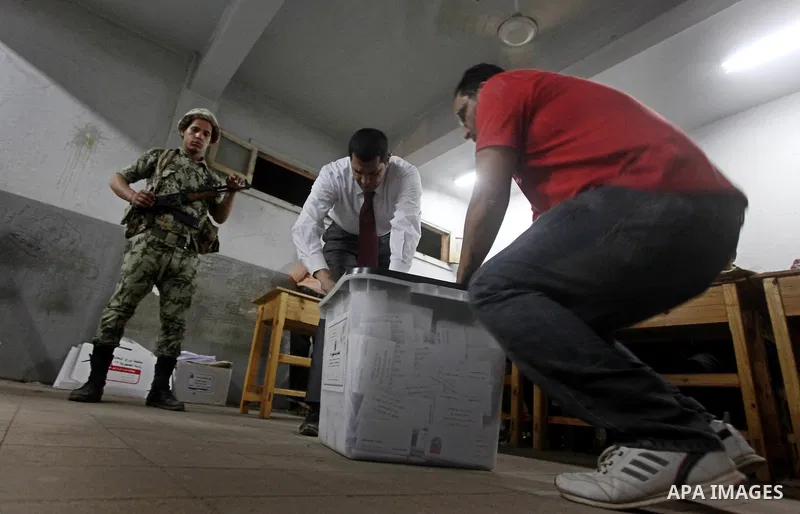 Egyptian election officials count ballots of the first round of Egypt's presidential elections, in a polling station in Cairo, Egypt, at the end of the election's second day on 24 May 2012. Polling stations closed at 9 p...