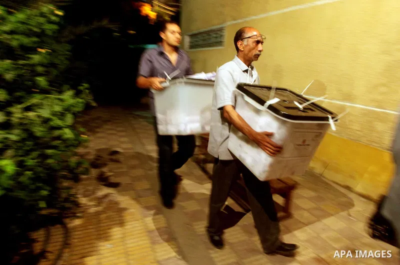 Egyptian election officials take sealed ballet boxs to count ballots of the first round of Egypt's presidential elections, in a polling station in Cairo, Egypt, at the end of the election's second day on 24 May 2012. Pol...