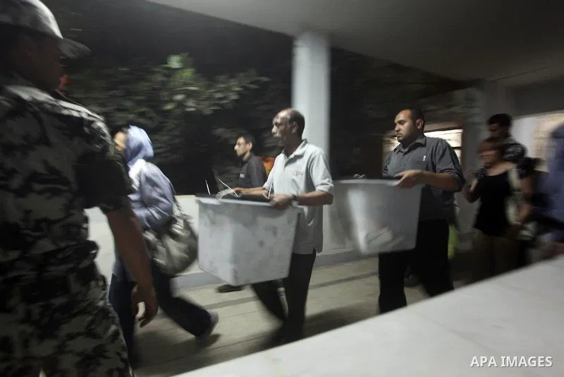 Egyptian election officials take sealed ballet boxs to count ballots of the first round of Egypt's presidential elections, in a polling station in Cairo, Egypt, at the end of the election's second day on 24 May 2012. Pol...