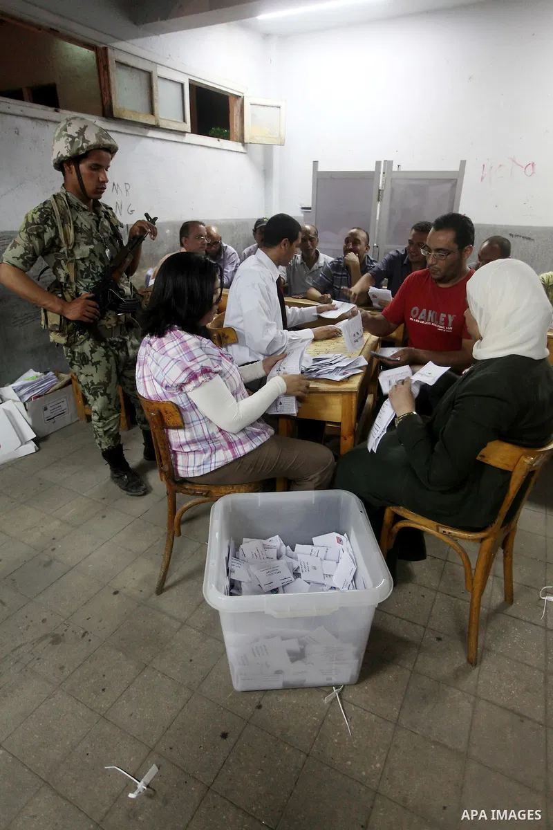 Egyptian election officials count ballots of the first round of Egypt's presidential elections, in a polling station in Cairo, Egypt, at the end of the election's second day on 24 May 2012. Polling stations closed at 9 p...