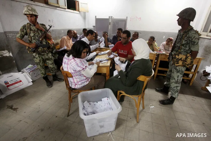 Egyptian election officials count ballots of the first round of Egypt's presidential elections, in a polling station in Cairo, Egypt, at the end of the election's second day on 24 May 2012. Polling stations closed at 9 p...