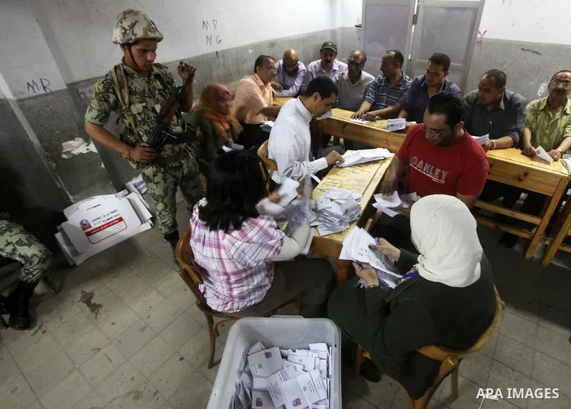 Egyptian election officials count ballots of the first round of Egypt's presidential elections, in a polling station in Cairo, Egypt, at the end of the election's second day on 24 May 2012. Polling stations closed at 9 p...