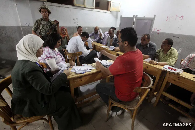 Egyptian election officials count ballots of the first round of Egypt's presidential elections, in a polling station in Cairo, Egypt, at the end of the election's second day on 24 May 2012. Polling stations closed at 9 p...