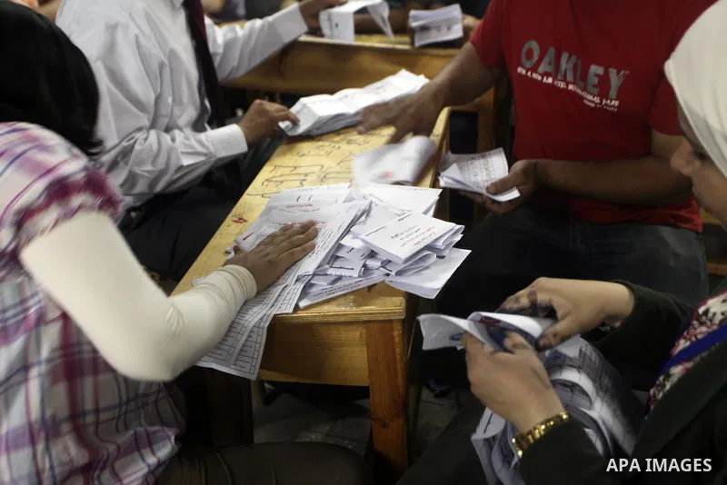 Egyptian election officials count ballots of the first round of Egypt's presidential elections, in a polling station in Cairo, Egypt, at the end of the election's second day on 24 May 2012. Polling stations closed at 9 p...