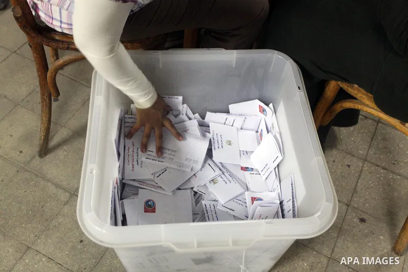 Egyptian election officials count ballots of the first round of Egypt's presidential elections, in a polling station in Cairo, Egypt, at the end of the election's second day on 24 May 2012. Polling stations closed at 9 p...