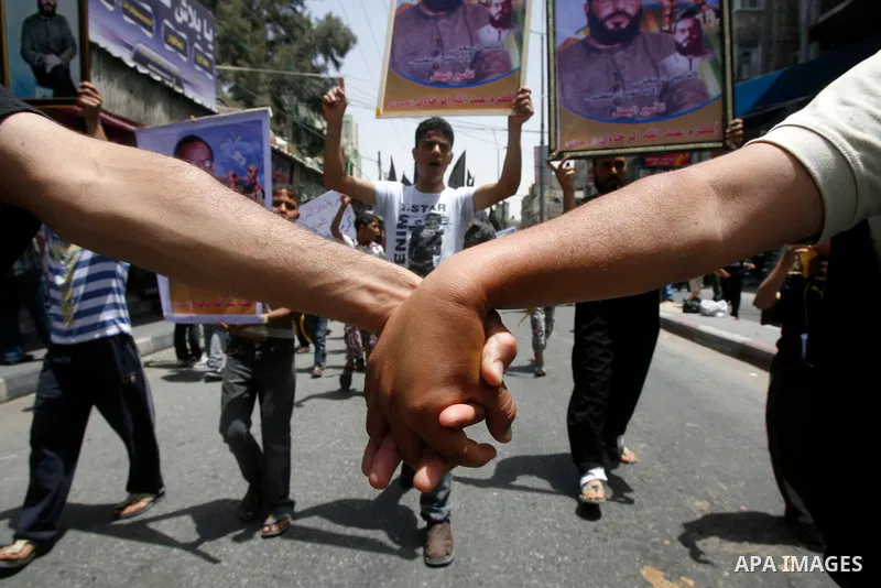 Palestinian Islamic Jihad members take part in a demonstration following friday prayers in solidarity with prisoners jailed in Israel after days from signing of a deal to end the prisoner's hunger strike, in Rafah refuge...