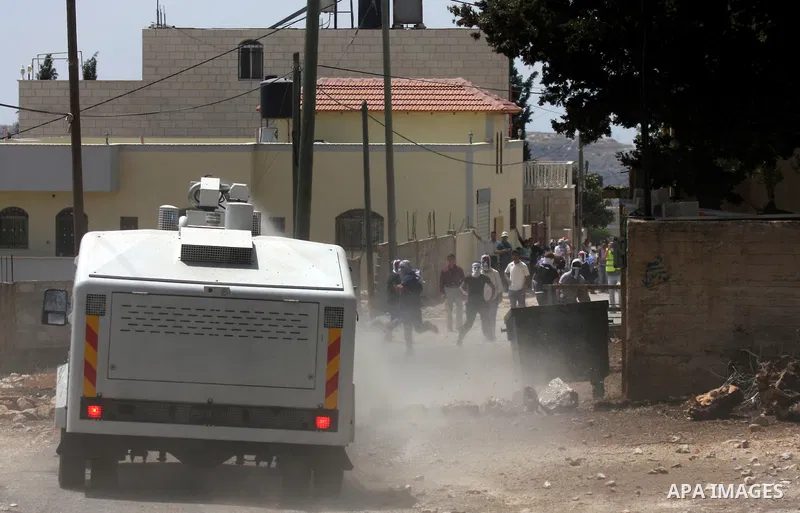 Israeli truck spray foul smelling water towards Palestinian protesters during clashes in the northern West Bank village of Kufr Qaddum, near the Jewish settlement of Kdumim, on May 25, 2012. Photo by Wagdi Eshtayah