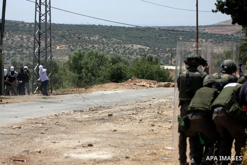 Palestinian protesters throw stones at Israeli soldiers during clashes in the northern West Bank village of Kufr Qaddum, near the Jewish settlement of Kdumim, on May 25, 2012. Photo by Wagdi Eshtayah