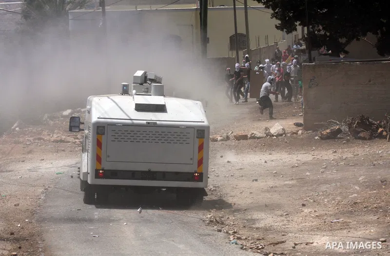 Israeli truck spray foul smelling water towards Palestinian protesters during clashes in the northern West Bank village of Kufr Qaddum, near the Jewish settlement of Kdumim, on May 25, 2012. Photo by Wagdi Eshtayah