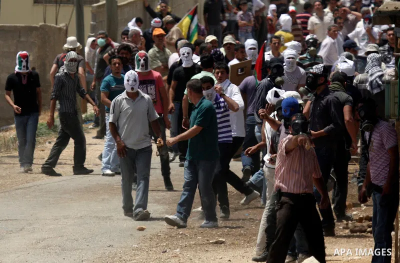Palestinian protesters throw stones at Israeli soldiers during clashes in the northern West Bank village of Kufr Qaddum, near the Jewish settlement of Kdumim, on May 25, 2012. Photo by Wagdi Eshtayah