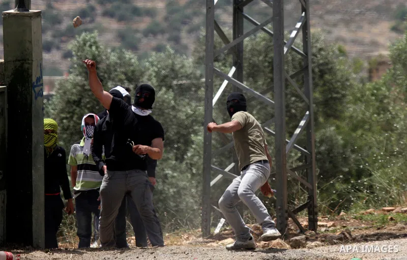 Palestinian protesters throw stones at Israeli soldiers during clashes in the northern West Bank village of Kufr Qaddum, near the Jewish settlement of Kdumim, on May 25, 2012. Photo by Wagdi Eshtayah