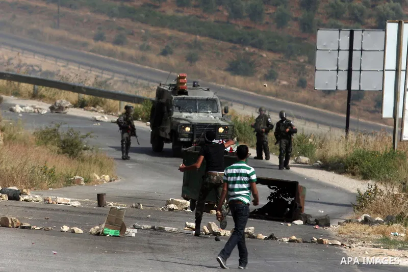Palestinian protesters hurl stones during clashes between stone throwers and Israeli soldiers in the West Bank village of Nabi Saleh, near Ramallah, on May 25, 2012 following a protest against the confiscation of Palesti...