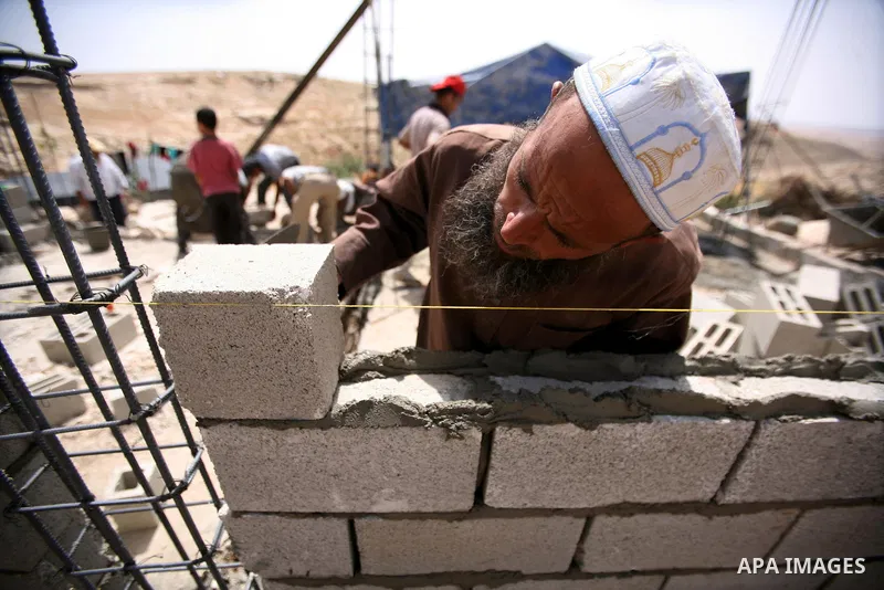 Palestinian workers build homes for Palestinians in the West Bank City of Hebron, on May 26, 2012 Palestinians whose houses were destroyed during Israeli military operations in West bank. Photo by Mamoun Wazwaz