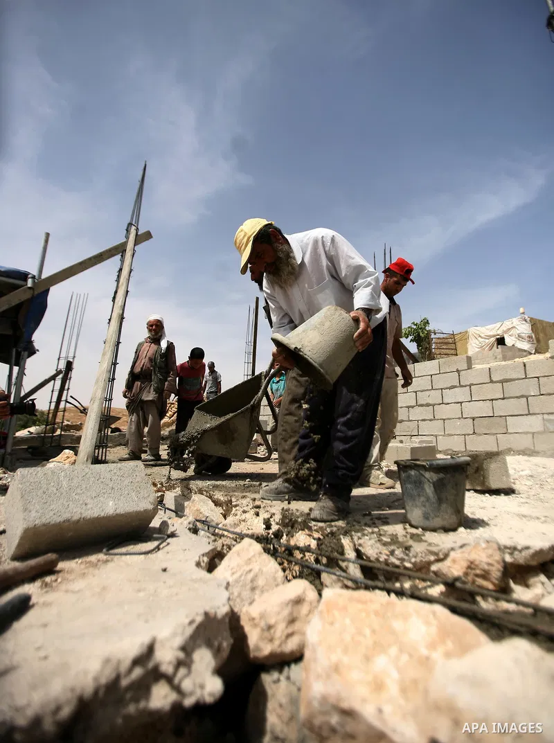 Palestinian workers build homes for Palestinians in the West Bank City of Hebron, on May 26, 2012 Palestinians whose houses were destroyed during Israeli military operations in West bank. Photo by Mamoun Wazwaz