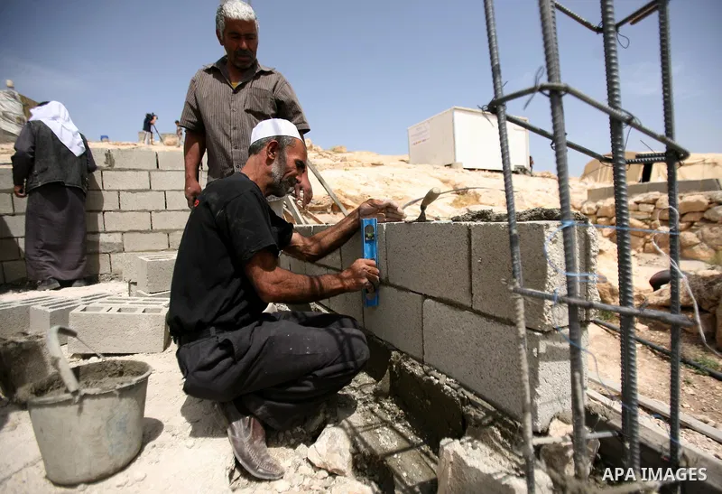 Palestinian workers build homes for Palestinians in the West Bank City of Hebron, on May 26, 2012 Palestinians whose houses were destroyed during Israeli military operations in West bank. Photo by Mamoun Wazwaz