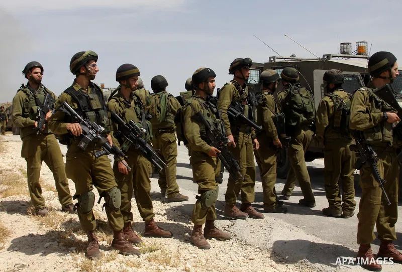 Palestinian protesters run for cover as Israeli forces fire in the air to disperse the crowd during clashes that followed the setting on fire of fields of grain and olive trees by hardline settlers from the Jewish settle...