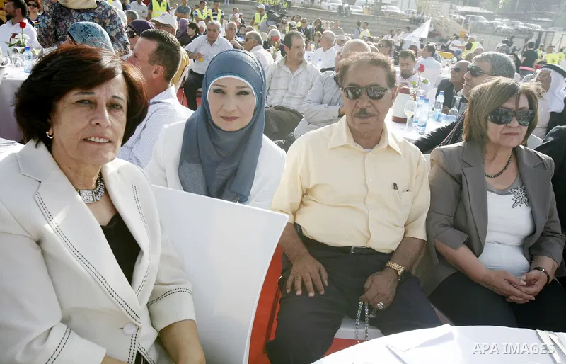 Palestinians participate a celebration in Arab east jerusalem after the longest buffet of natural and organic food registered a new Guinness world record. -- Palestinians serve food from the longest buffet table of natur...