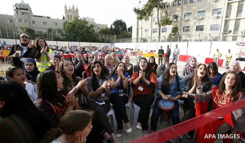 Palestinians participate a celebration in Arab east jerusalem after the longest buffet of natural and organic food registered a new Guinness world record. -- Palestinians serve food from the longest buffet table of natur...