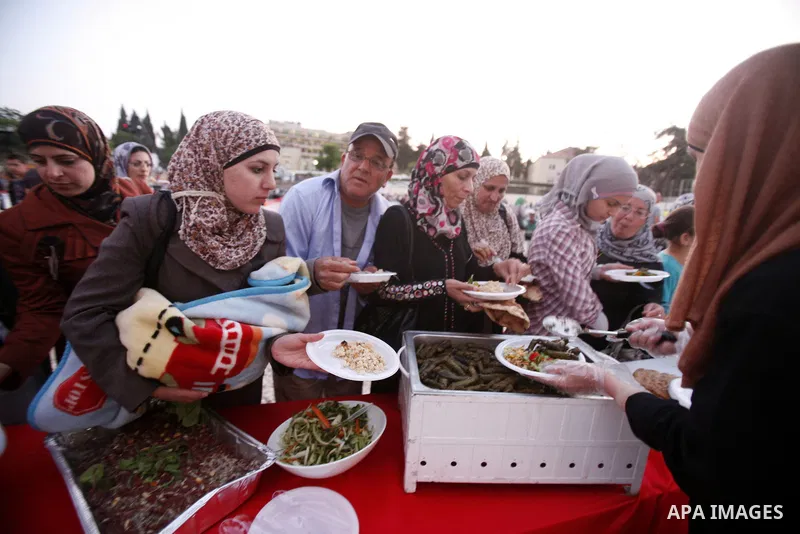 Palestinians serve food from the longest buffet table of natural and organic food, officially setting a new Guinness world record. on May 26, 2012 in Arab east jerusalem. The Palestinian banquet, prepared by Jerusalem lo...