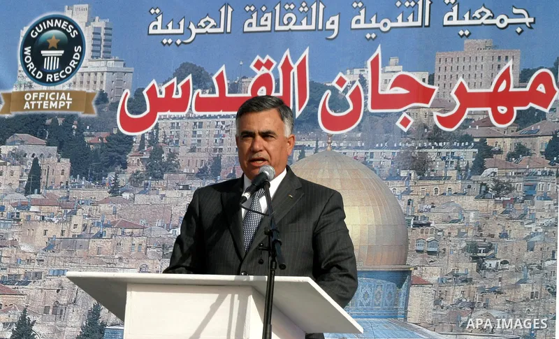 Palestinians participate a celebration in Arab east jerusalem after the longest buffet of natural and organic food registered a new Guinness world record. -- Palestinians serve food from the longest buffet table of natur...