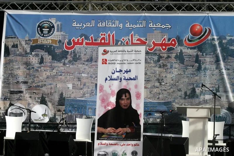 Palestinians participate a celebration in Arab east jerusalem after the longest buffet of natural and organic food registered a new Guinness world record. -- Palestinians serve food from the longest buffet table of natur...