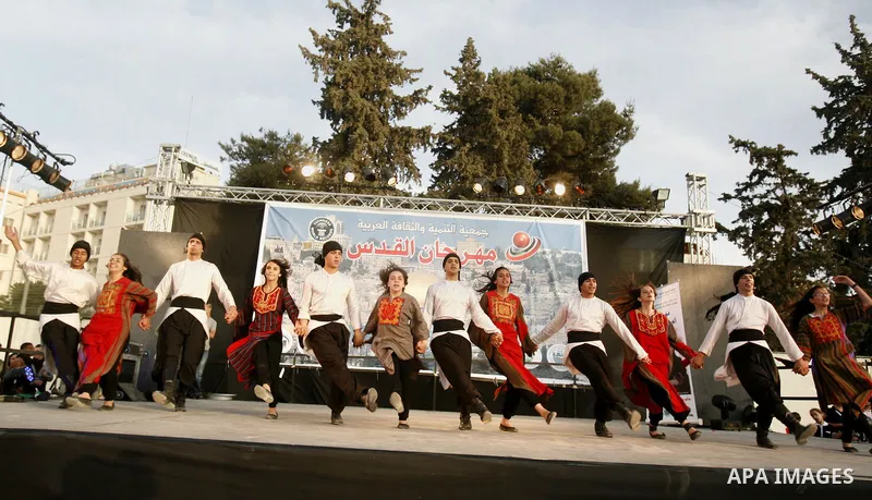 A Palestinian folkloric dance troupe performs during a celebration in Arab east jerusalem after the longest buffet of natural and organic food registered a new Guinness world record, on May 26, 2012 in Arab east jerusale...