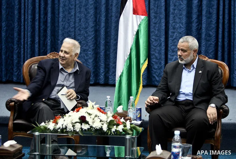 The head of Gaza's Hamas government, Ismail Haniya (C-R), meets with members of the Central Elections Commission in Gaza City on May 28, 2012 as CEC officials prepare to begin work on updating the electoral register in t...