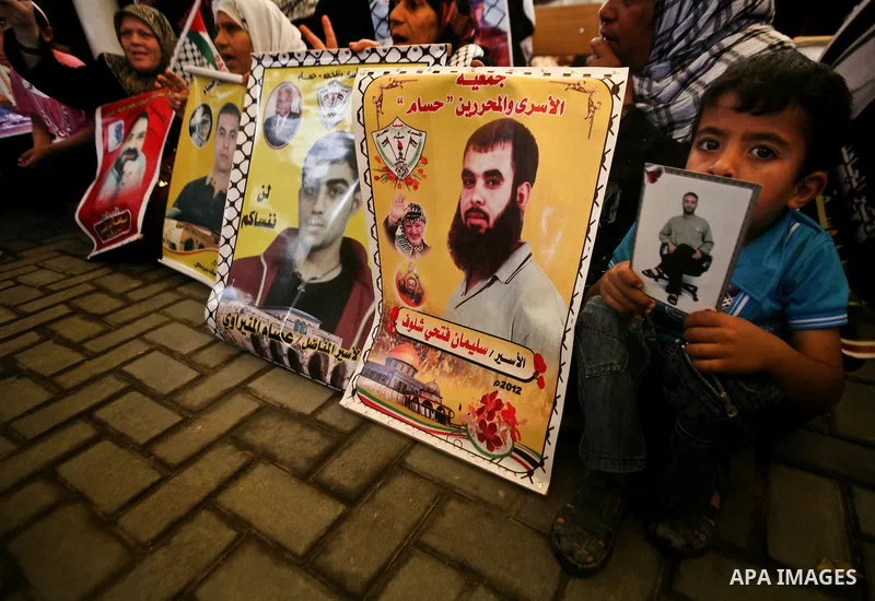 Relatives of Palestinian prisoners participate a protest at the Red Cross' offices in Gaza City to call for the release of Palestinian prisoners held in Israeli jails, on May. 28, 2012. Photo by Ali Jadallah