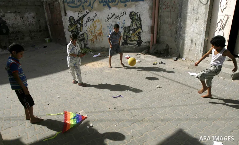 Palestinian refugees children play the football at the street during the summer holiday in the Rafah refugee camp southern Gaza Strip on May 29, 2012. Photo by Eyad Al Baba