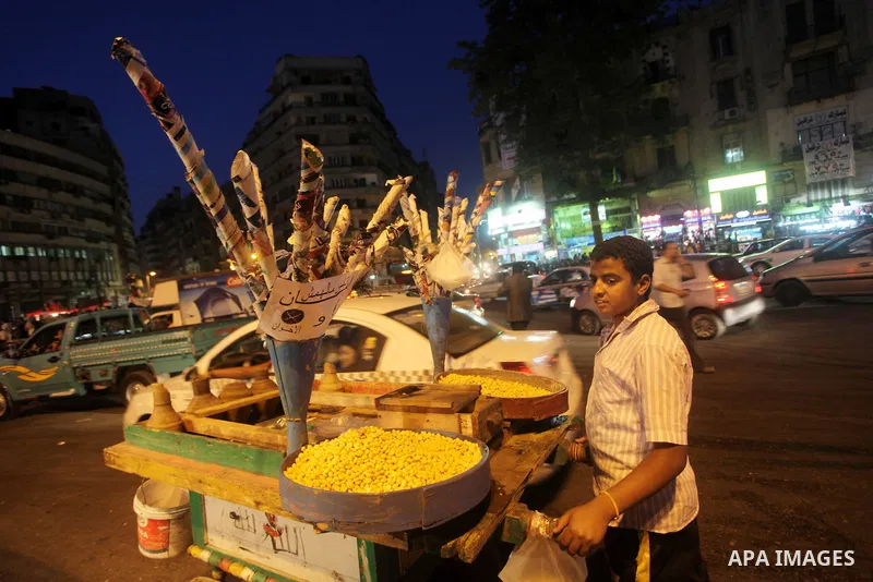 An Egyptian man sells nuts during a demonstration against presidential candidates Mohammed Morsi and Ahmed Shafiq at Tahrir Square in Cairo May 29, 2012. According to full official results released Monday by the election...