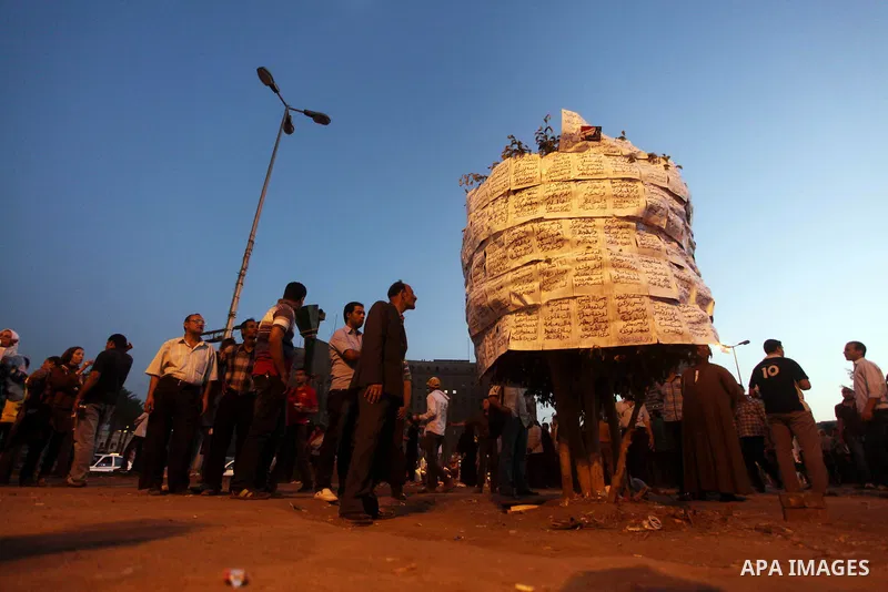 Egyptian protesters read slogans against presidential candidates Mohammed Morsi and Ahmed Shafiq at Tahrir Square in Cairo May 29, 2012. According to full official results released Monday by the election commission. Comm...