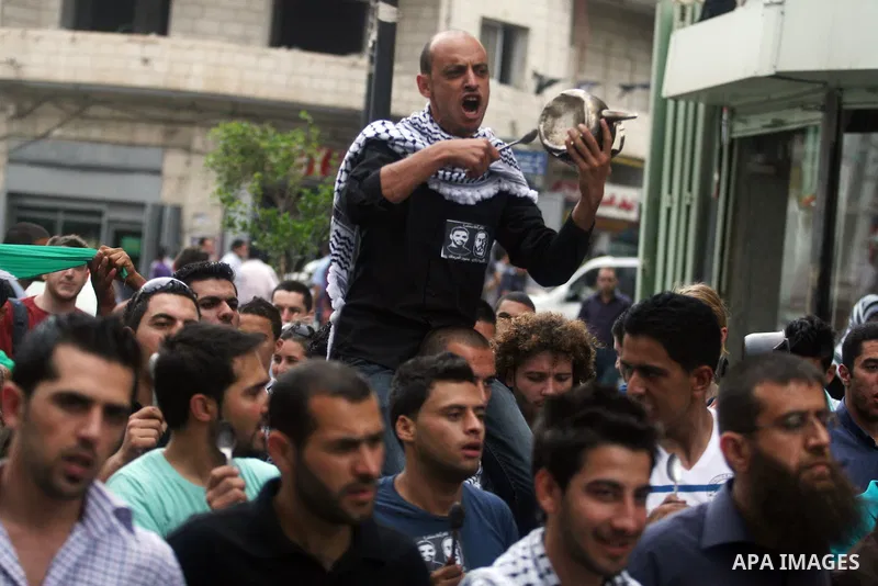 Palestinian protestors bang on pots covered in pictures of Palestinian prisoners Mahmoud al-Sarsak and Akram al-Rikhawi, who are still refusing food a week after a deal was made to end a mass prisoner hunger strike, duri...