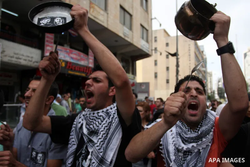 Palestinian protestors bang on pots covered in pictures of Palestinian prisoners Mahmoud al-Sarsak and Akram al-Rikhawi, who are still refusing food a week after a deal was made to end a mass prisoner hunger strike, duri...