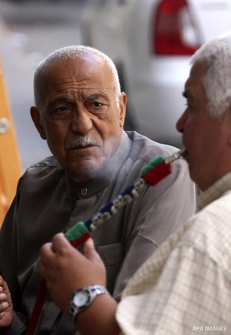 Palestinian elderly smoking water pipes at cafe in the West Bank city of Nablus, on May 30, 2012. Photo by Wajdi Eshtaya
