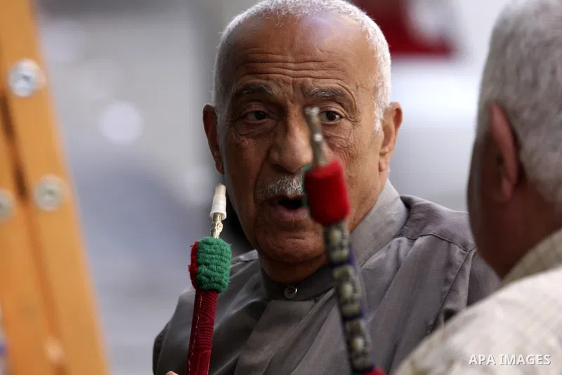 Palestinian elderly smoking water pipes at cafe in the West Bank city of Nablus, on May 30, 2012. Photo by Wajdi Eshtaya