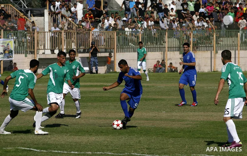 Players from Rafah Youth Club play against the players from Rafah Services Club during a football match in the League Cup of the Gaza Strip at Rafah Municipality Stadium in the southern Gaza Strip on May 30, 2012. Photo...
